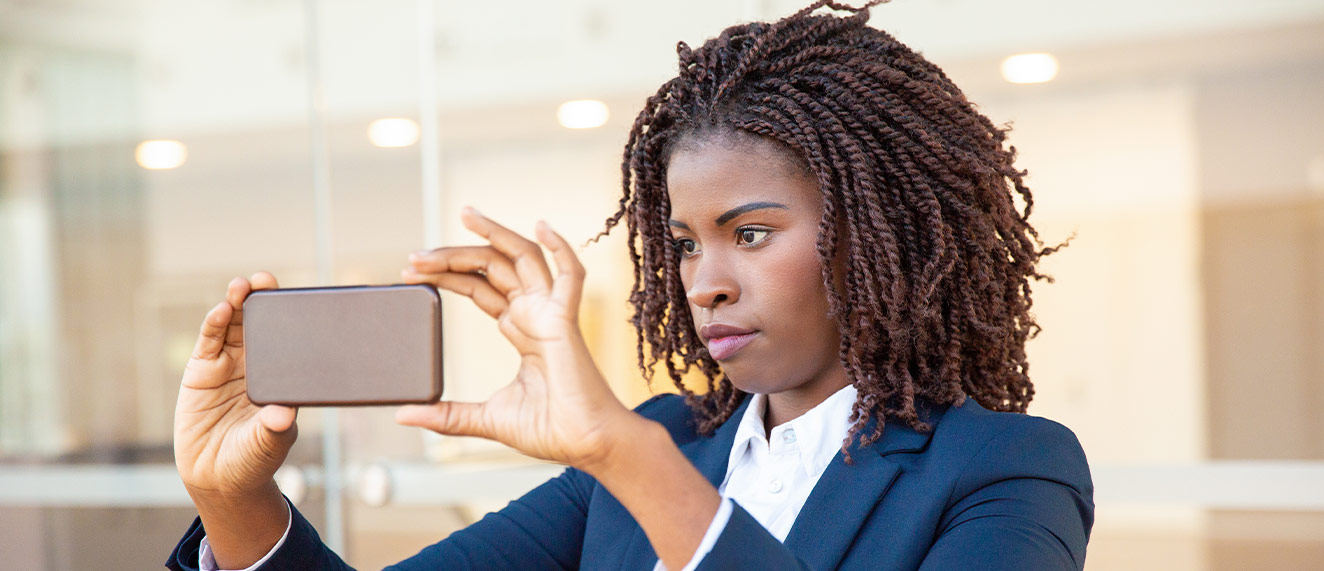 Woman taking photo on phone.