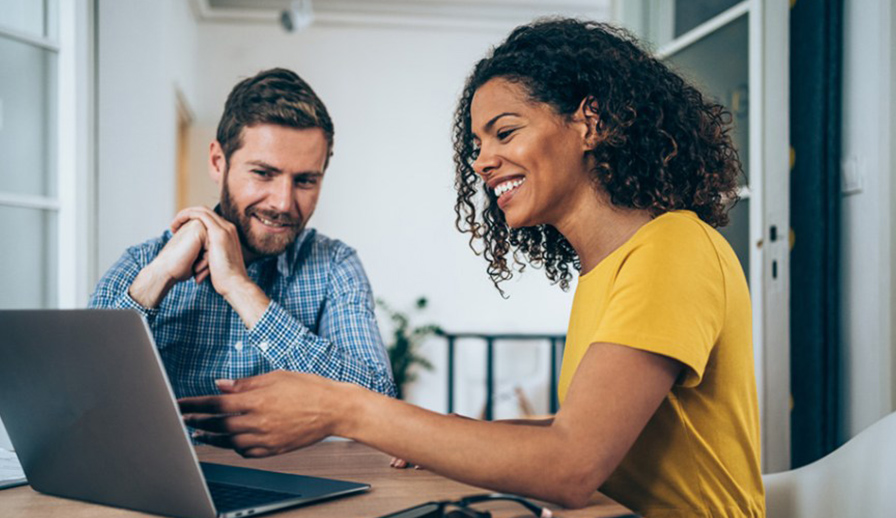 Couple looking at a laptop together.