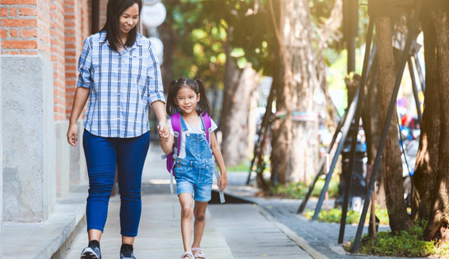 Mother walking with her daughter.