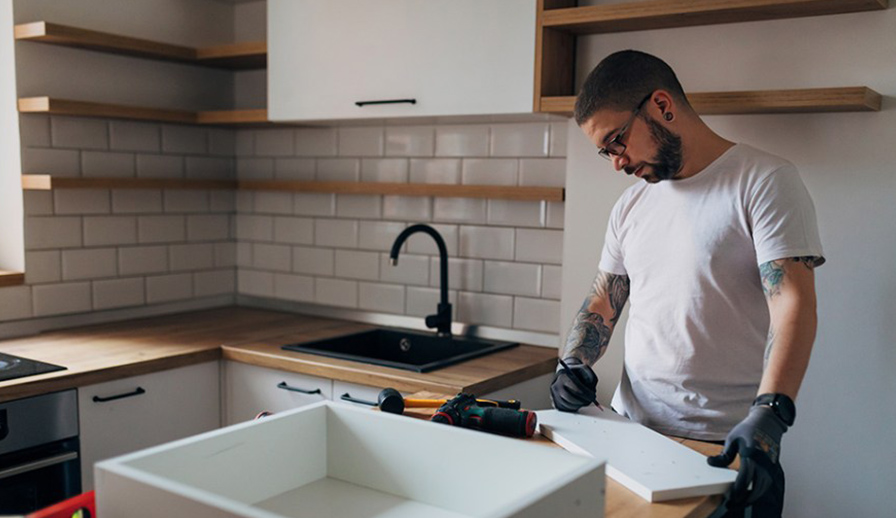 Man working on updating kitchen.