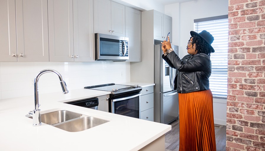 Woman standing in kitchen.